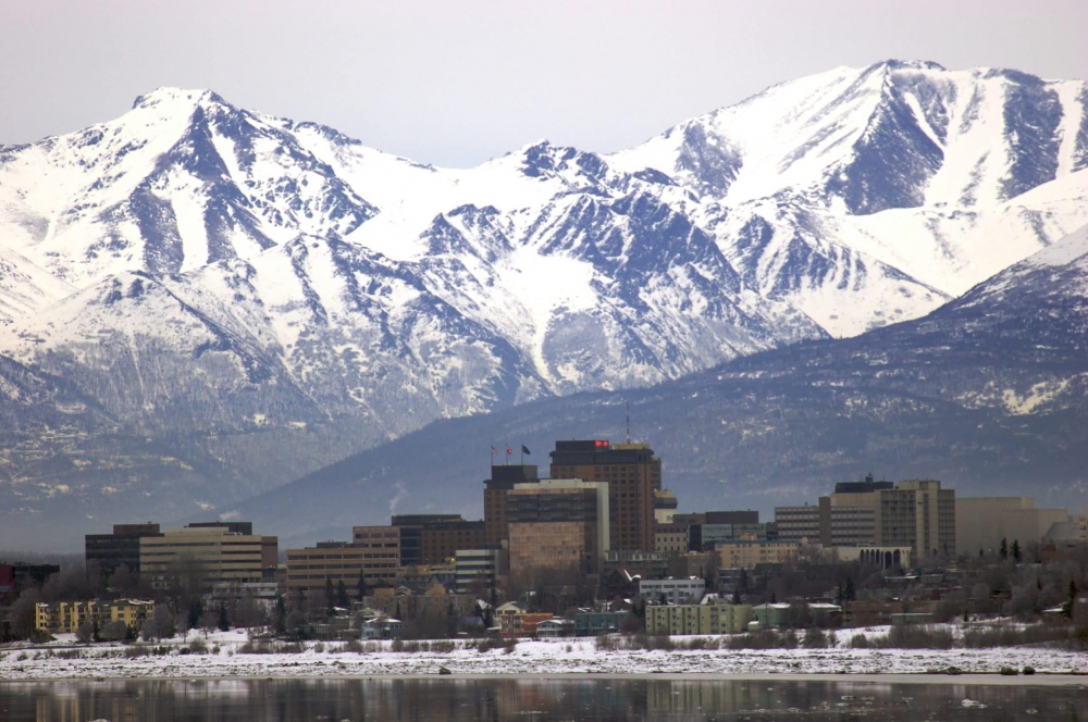 A mountain range over the Anchorage, AK skyline.